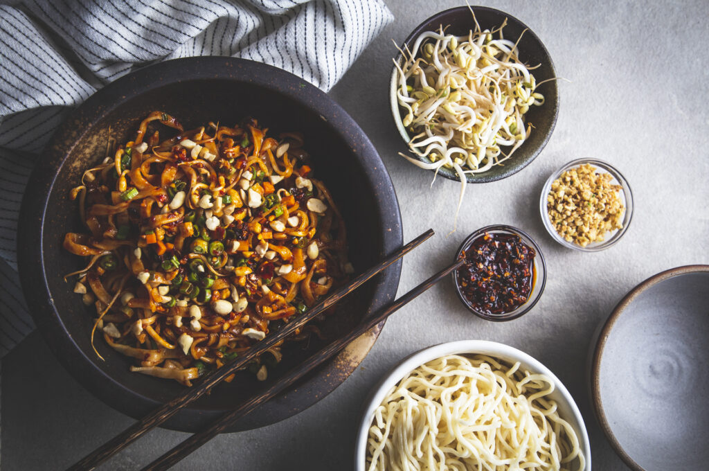 Asian Noodles with chopsticks on a grey table