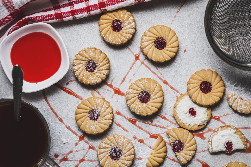 Jim jam biscuits on a grey background with strawberry jam