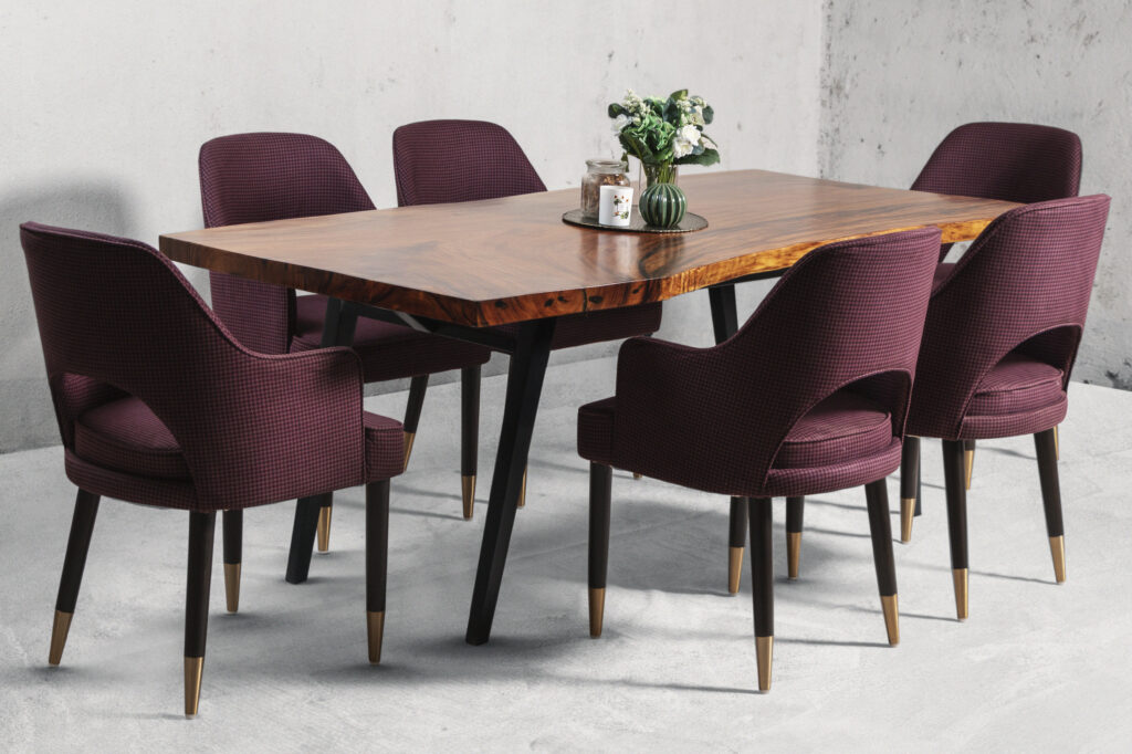 A 6 seater dining table made from mahogany wood with burgundy chairs